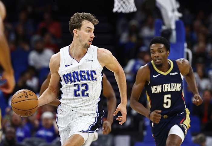 Orlando Magic forward Franz Wagner (22) dribbles as New Orleans Pelicans forward Herbert Jones (5) defends during the first quarter at Amway Center.